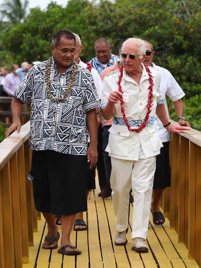 King Charles III and Minister Toeolesulusulu Cedric Schuster walk across a restored boardwalk as the King visits the Mangrove Restoration Project at Moata'a Village, near Apia. Picture: Getty Images