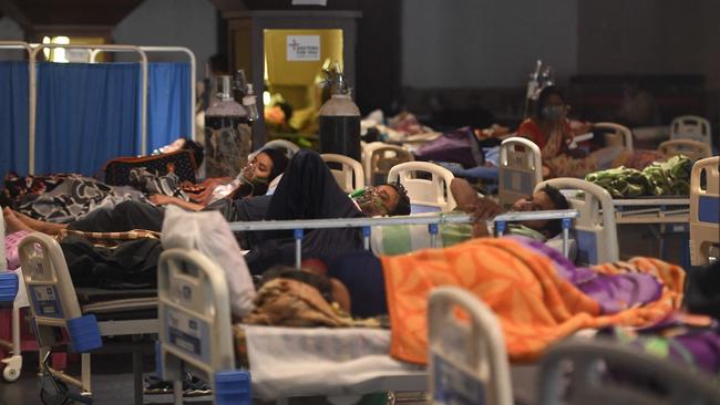 People breath with the help of oxygen masks inside a banquet hall temporarily converted into a Covid-19 coronavirus ward in New Delhi on Tuesday. Picture: AFP