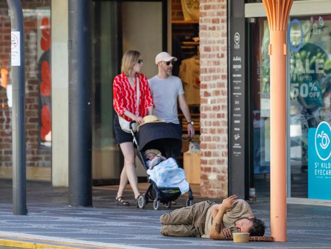 MELBOURNE, JANUARY 10, 2024: A man sleeps on the ground in Acland Street, St Kilda. Picture: Mark Stewart