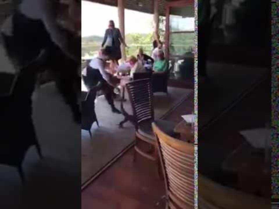 Brave waiter drags struggling Goanna from restaurant