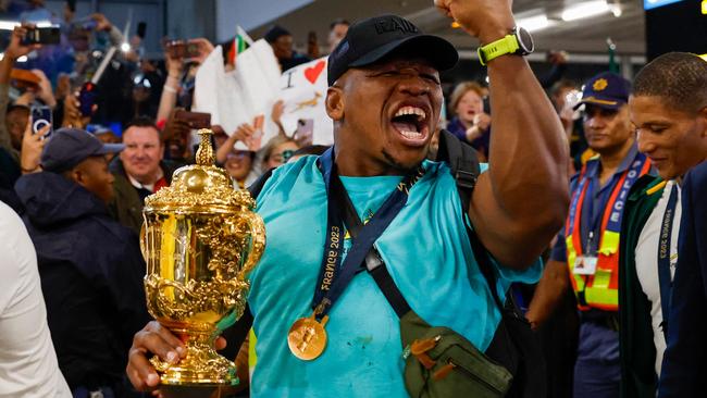 Bongi Mbonambi with the Webb Ellis Cup on arrival back in South Africa after the World Cup. Picture: AFP