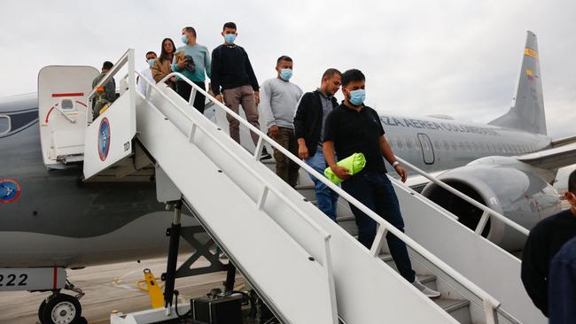 Migrants leaving a Colombian Air Force plane in Bogota after being deported from the US on Tuesday. Picture: AFP