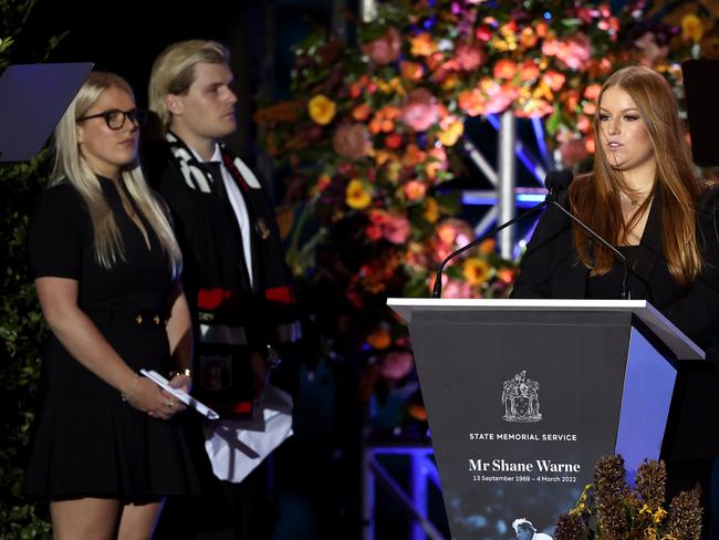 MELBOURNE, AUSTRALIA - MARCH 30: Summer Warne speaks on stage alongside Jackson Warne and Brooke Warne during the state memorial service for former Australian cricketer Shane Warne at the Melbourne Cricket Ground on March 30, 2022 in Melbourne, Australia. Warne died suddenly aged 52 on Friday 4 March while on holiday in Thailand. (Photo by Robert Cianflone/Getty Images)