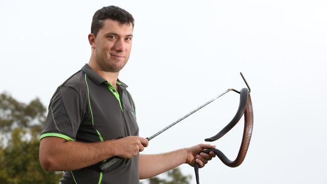 Snake catcher Patrick Reeve, from Sydney Metropolitan Wildlife Services, with a red-bellied black snake.