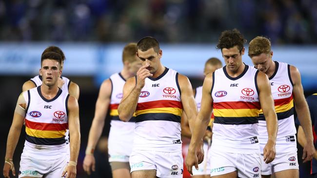 Adelaide’s Taylor Walker leads teammates off the ground following Round 4 loss to North Melbourne at Marvel Stadium. Picture: Scott Barbour/Getty Images.