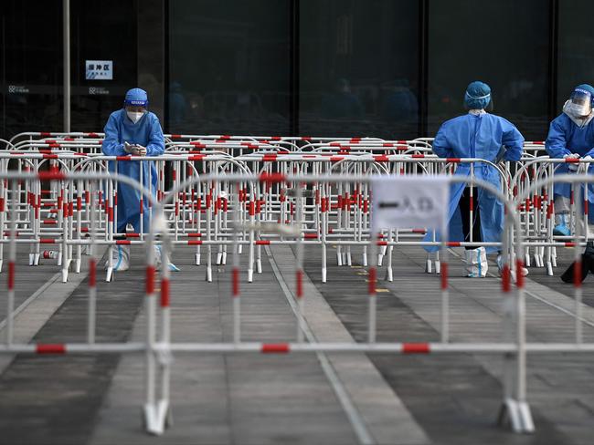 Health workers wait at a Covid-19 testing site in Beijing on June 12, 2022. Picture: Noel Celis / AFP