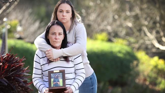 Tonyalee Boxall and her mother Caroline Miller, holding Onyx’s ashes, say they were forced to euthanise the 18-month-old rottweiler after “botched” surgeries. Picture: David Caird.