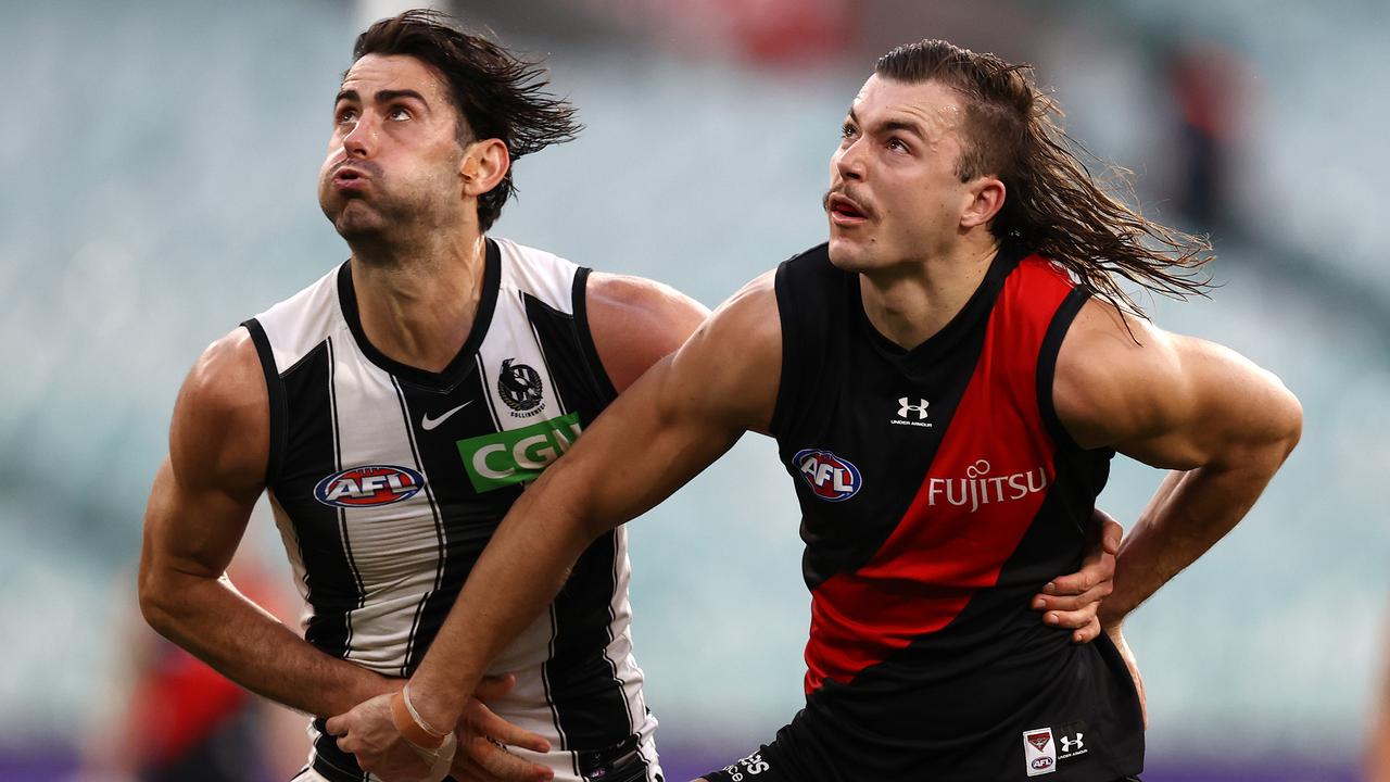 MELBOURNE, AUSTRALIA - AUGUST 21, 2021: Sam Draper of the Bombers and Brodie Grundy of the Magpies during the round 23 AFL match between Essendon and Collingwood at the MCG, on August 22, 2021, in Melbourne, Australia. (Photo by Michael Klein)