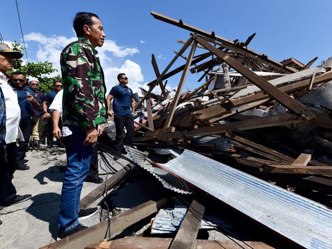 Indonesian President Joko Widodo surveys the damage after a tsunami devastated the region. Picture: AP