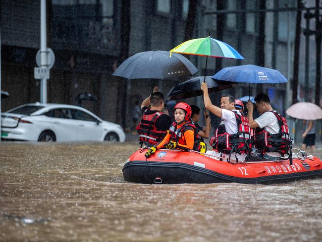 TOPSHOT - Rescue workers ride a boat along a flooded street in Shenzhen, in China's Guangdong province on September 8, 2023, after the city recorded the heaviest rains since records began in 1952. (Photo by AFP) / China OUT