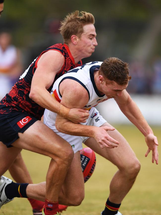 Adelaide Crow connector Tom Lynch under pressure from Bernie Vince in Alice Springs. Picture: AAP Image/Mark Brake