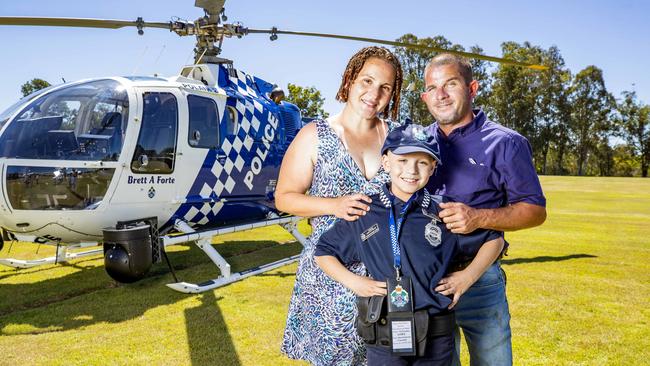 Christopher Lowe with parents Injilay and Ian. Picture: Richard Walker