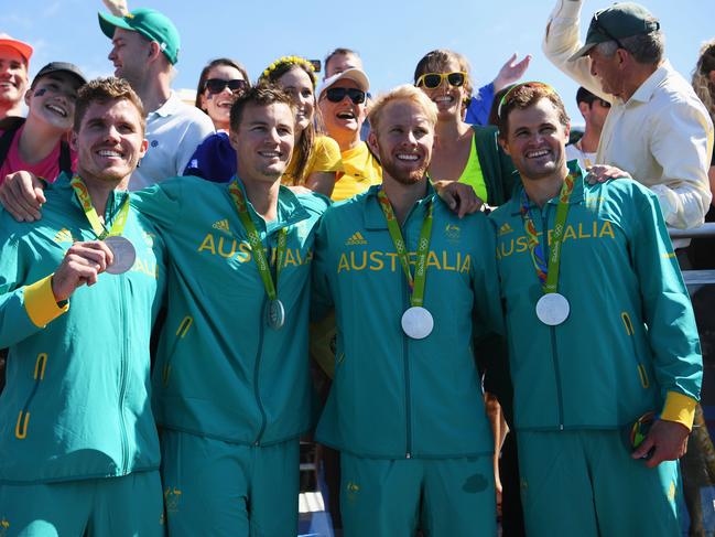 Karsten Forsterling, Alexander Belonogoff, Cameron Girdlestone and James McRae celebrate with their silver medals after finishing second in the men’s quadruple sculls