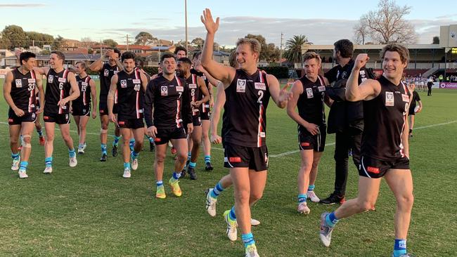 Frankston players acknowledge their supporters after today’s win.