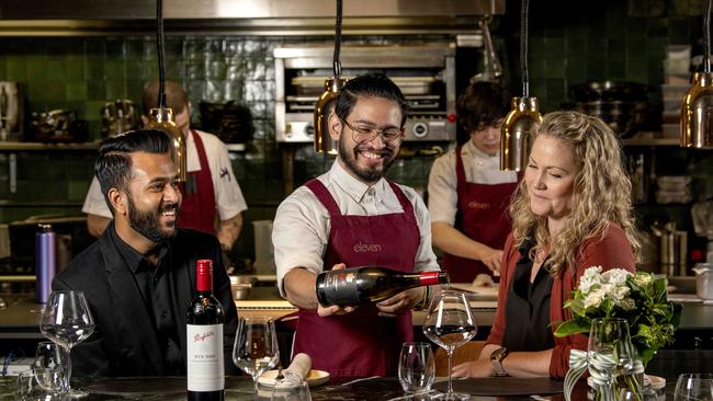 Eleven recently hosted a $300 a head dinner with Penfolds. Staff member Clayton Johnson serving Divesh Lormorh and Nikki Potter. Picture: Naomi Jellicoe