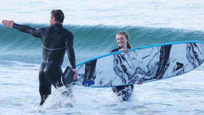 Hemsworth stopped to help a fellow surfer. Picture: Matrix