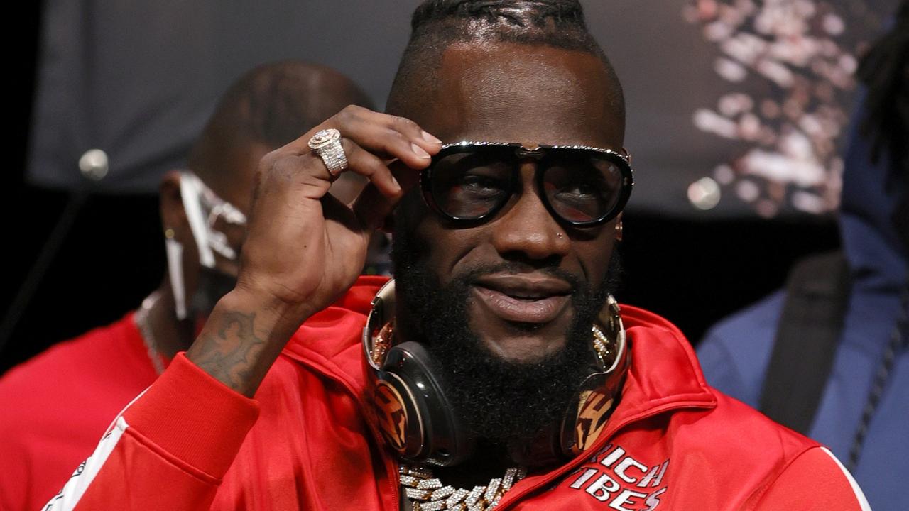Deontay Wilder smiles during a news conference at MGM Grand Garden Arena.