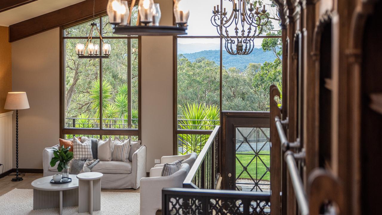 Exposed roof beams and floor to ceiling windows look out over Upper Beaconsfield.