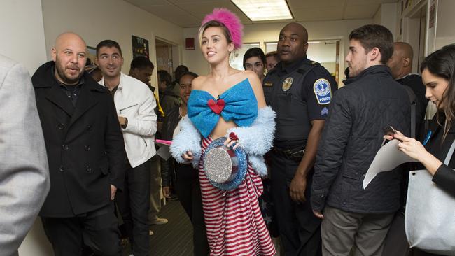 Cyrus walking through the halls of George Mason University.