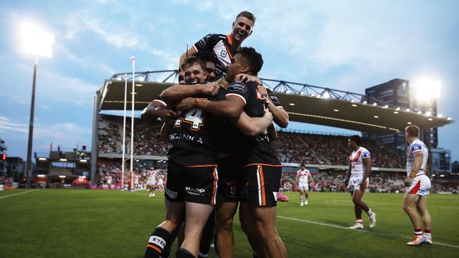 Zac Cini of the Tigers celebrates with teammates after scoring a try during the round eight NRL match against St George Illawarra. Picture: Matt King/Getty Images