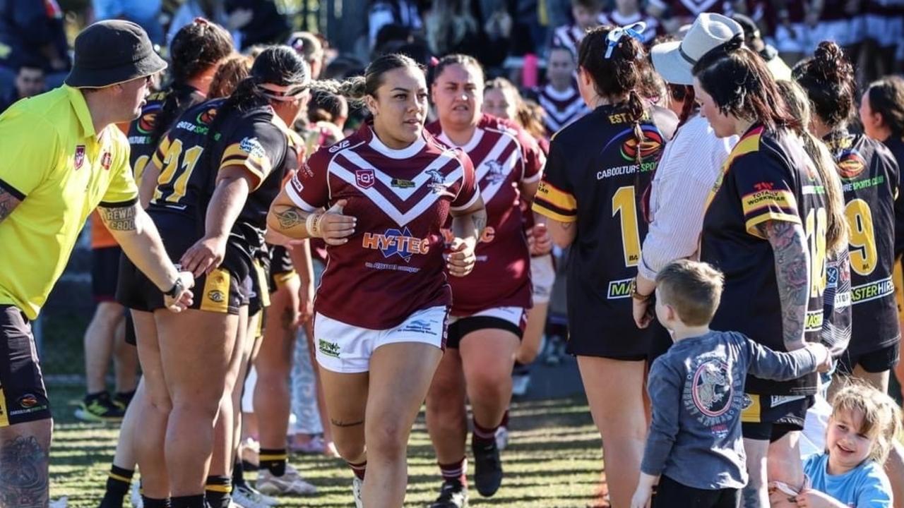 Maarire Puketapu leads her Kawana Dolphins team onto the field. Picture: Richie Jarman/Infamous Photography.