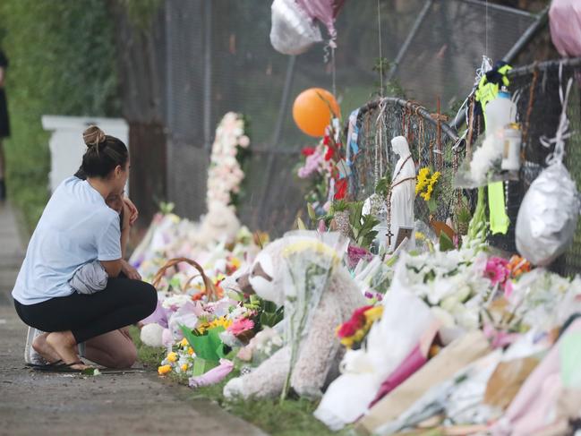 Relatives of the four children who were killed by a drunk and drugged driver in 2020 view the memorial for the victims. Picture: John Grainger