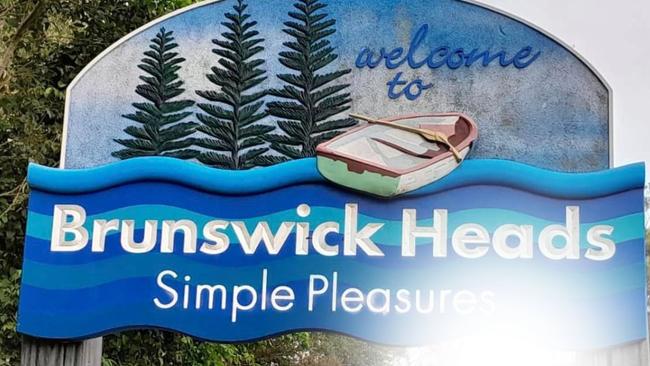 The entry signage into Brunswick Heads has been defaced with a rude message. Picture: Supplied / Facebook.