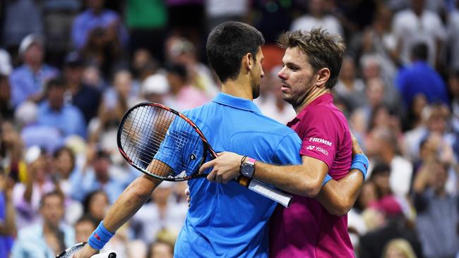 Wawrinka and Djokovic embrace each other after the match