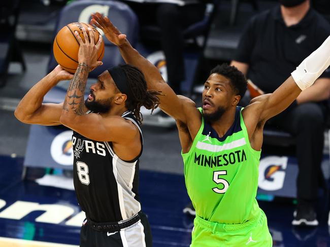 Malik Beasley guards AUSSIE Patty Mills.