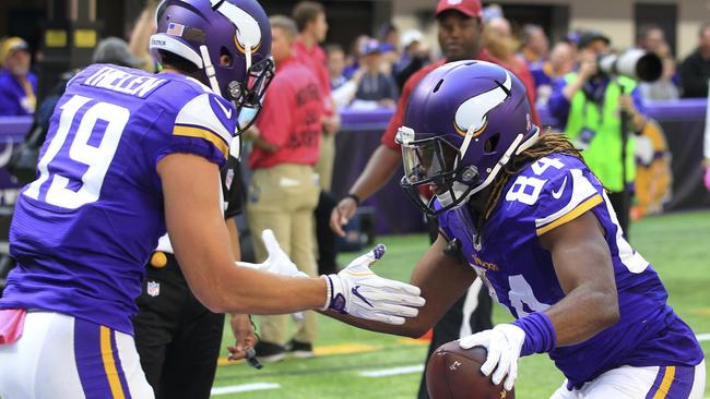 Minnesota Vikings wide receiver Cordarrelle Patterson, right, celebrates with teammate Adam Thielen, left, after catching a 9-yard touchdown pass.