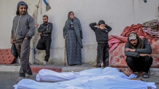 People mourn at Al-Shifa hospital in Gaza City, over the bodies of Palestinians killed in an early morning incident when Israeli forces opened fire on crowds rushing at an aid distribution point, on February 29, 2024. Picture: AFP