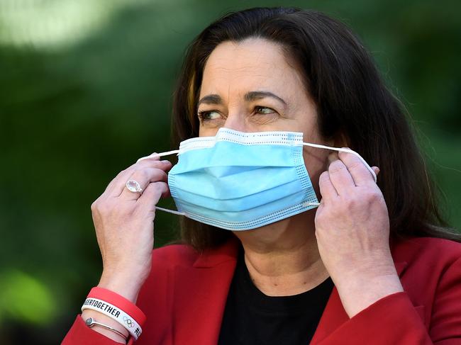 BRISBANE, AUSTRALIA - NewsWire Photos - AUGUST 8, 2021. Queensland Premier Annastacia Palaszczuk puts on her mask during a media conference at Parliament House to provide a Covid-19 update.Picture: NCA NewsWire / Dan Peled