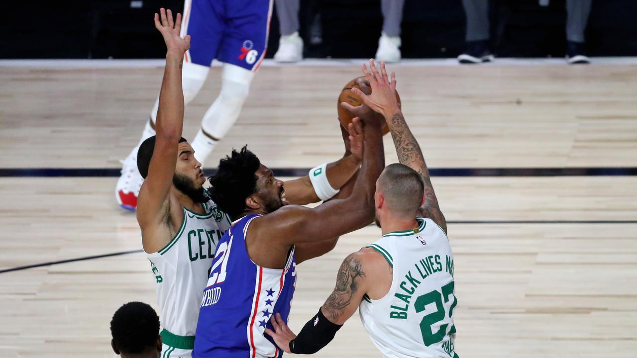 LAKE BUENA VISTA, FLORIDA - AUGUST 21: Joel Embiid #21 of the Philadelphia 76ers drives against Jayson Tatum #0 and Daniel Theis #27 of the Boston Celtics during the first half in Game Three of the first round of the NBA Playoffs at The Field House at ESPN Wide World Of Sports Complex on August 21, 2020 in Lake Buena Vista, Florida. NOTE TO USER: User expressly acknowledges and agrees that, by downloading and or using this photograph, User is consenting to the terms and conditions of the Getty Images License Agreement. (Photo by Kim Klement - Pool/Getty Images)