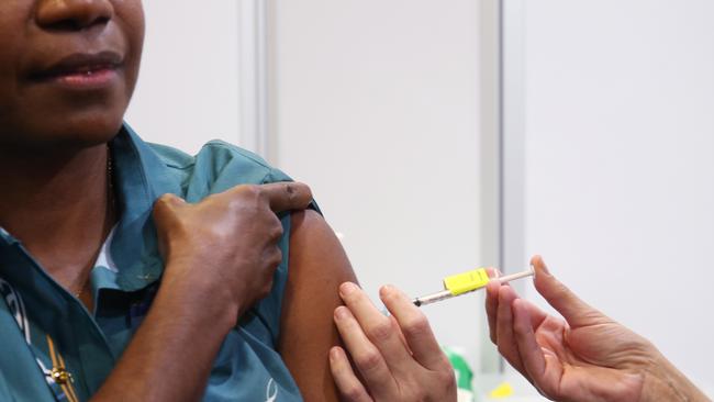 A Pfizer Covid-19 vaccine is administered to a Aboriginal and Torres Strait Islander liaison officer. Picture: Brendan Radke