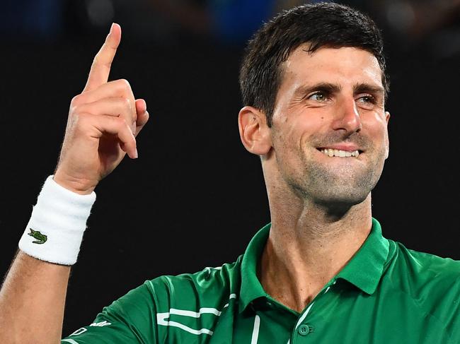 (FILES) This file photo taken on January 30, 2020 shows Serbia's Novak Djokovic celebrating after beating Switzerland's Roger Federer during their men's singles semi-final match on day 11 of the Australian Open tennis tournament in Melbourne. - World number one Novak Djokovic won a stunning victory on January 10, 2022 over the Australian government, overturning the cancellation of his visa on Covid-19 health grounds, and ending his detention. (Photo by William WEST / AFP) / -- IMAGE RESTRICTED TO EDITORIAL USE - STRICTLY NO COMMERCIAL USE --