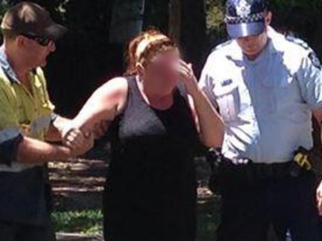 Police help a distressed family friend outside the house. Picture: Sharnie Kim, ABC