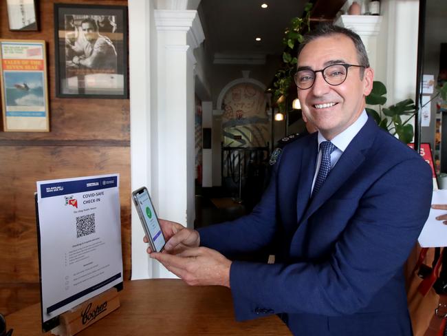 South Australian Premier Steven Marshall demonstrates checking in via QR code to help with contact tracing at the Stag Hotel. Picture: Kelly Barnes/Getty Images