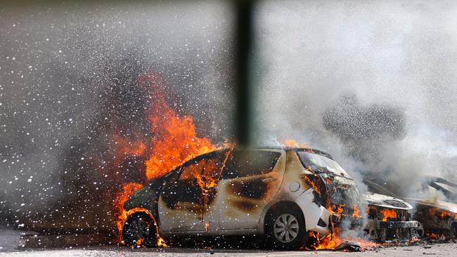 Cars are seen on fire following a rocket attack from the Gaza Strip in Ashkelon, southern Israel. Picture: Ahmad Gharabli / AFP