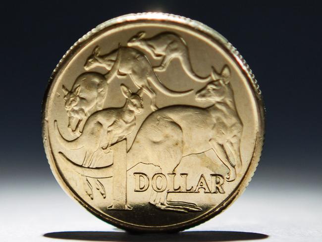 An Australian one-dollar coin is arranged for a photograph in Sydney, Australia, on Wednesday, April 17, 2013. Direct trading between the Australian dollar and yuan started on April 10. Photographer: Ian Waldie/Bloomberg