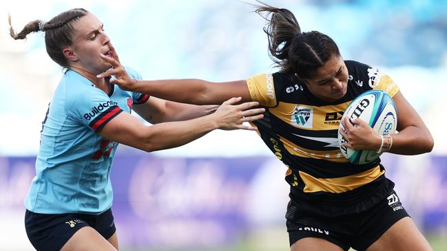 Langley Sesega fends off Ella Ryan in the opening round of Super W. Pictures: Matt King/Getty Images