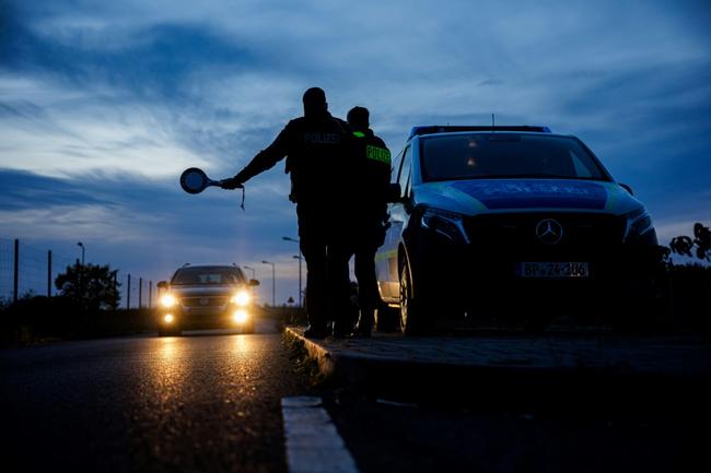 German Federal Police stop a car near Forst, eastern Germany, on October 11, 2023, near the border with Poland