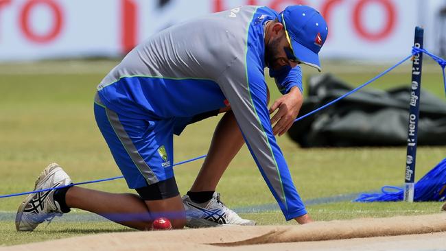 Australian cricketer Nathan Lyon inspects the pitch at Galle in 2016. Picture: AFP PHOTO / ISHARA S. KODIKARA