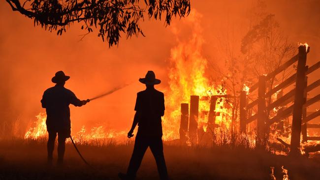 Residents defend a property from a bushfire at Hillsville near Taree. Picture: Peter Parks/AFP