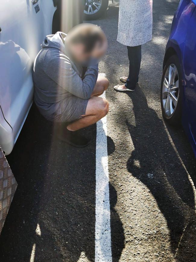 Police arrest one of the men during a raid. Picture: AFP Media