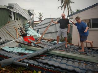 Peter and Jenny Davis start the cleanup of the rear section of their house, which was demolished during Cyclone Yasi, at Cowley Beach in 2006.