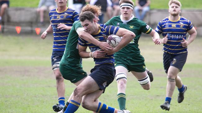 Taj Annan getting tackled in Colts 1 action between Wests and Easts. Photo credit: Holly Hope Creative.