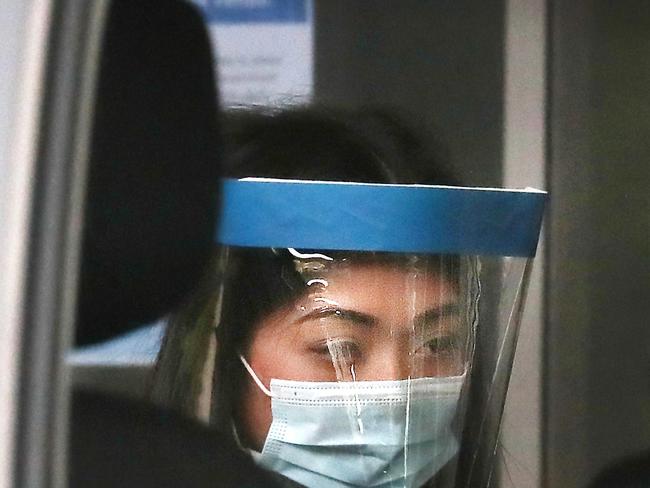 Sarah Caisip about to see her dad for the last time after his funeral at the Mt Gravatt Cemetery. Picture: Annette Dew