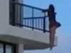 Girl dangles from Qld balcony for photo