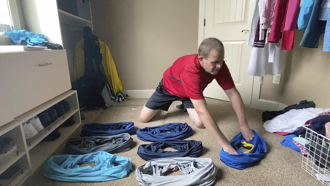 David Rush preparing to put on T-shirts at home in Idaho, US. Picture: David Rush via AP