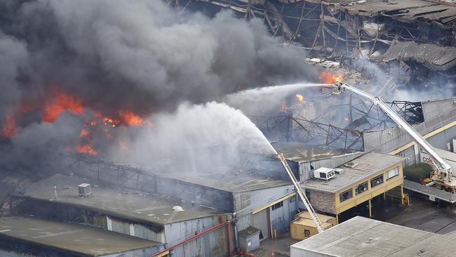 Toxic black smoke from an out-of-control fire at a factory in West Footscray. Picture: David Caird